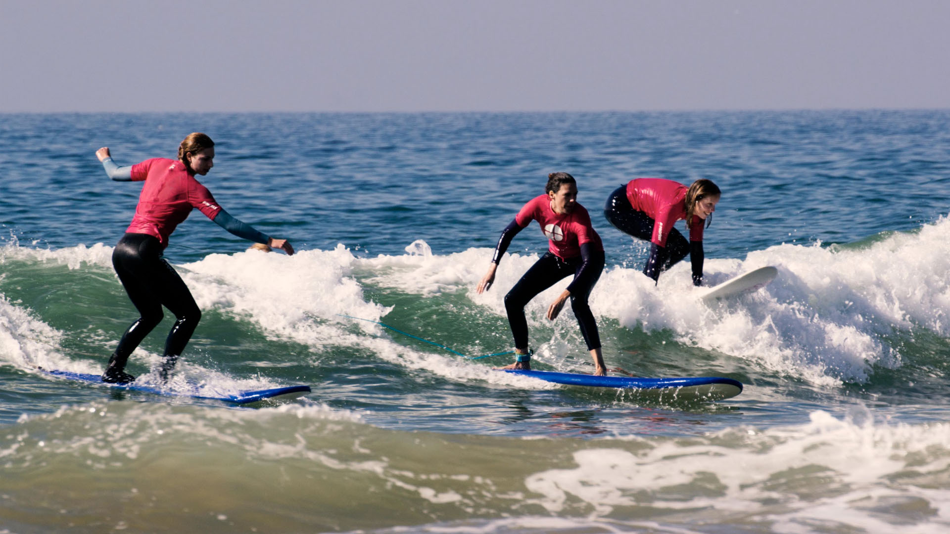 Beginner surfer at Banana Point Taghazout catching a small wave