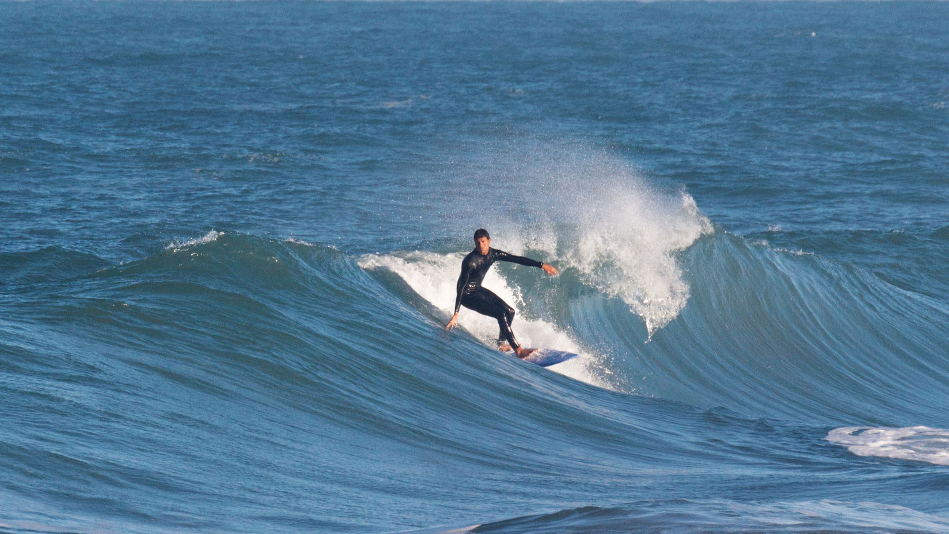Devil's Rock Morocco winter surf – surfer dropping into a steep right-hand wave