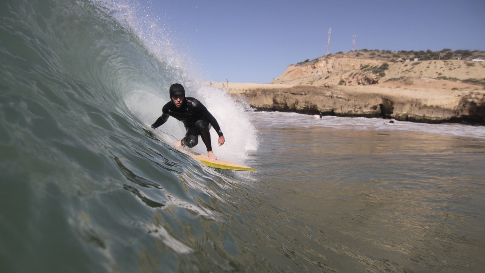 Intermediate surfer at Taghazout Main Point performing a bottom turn
