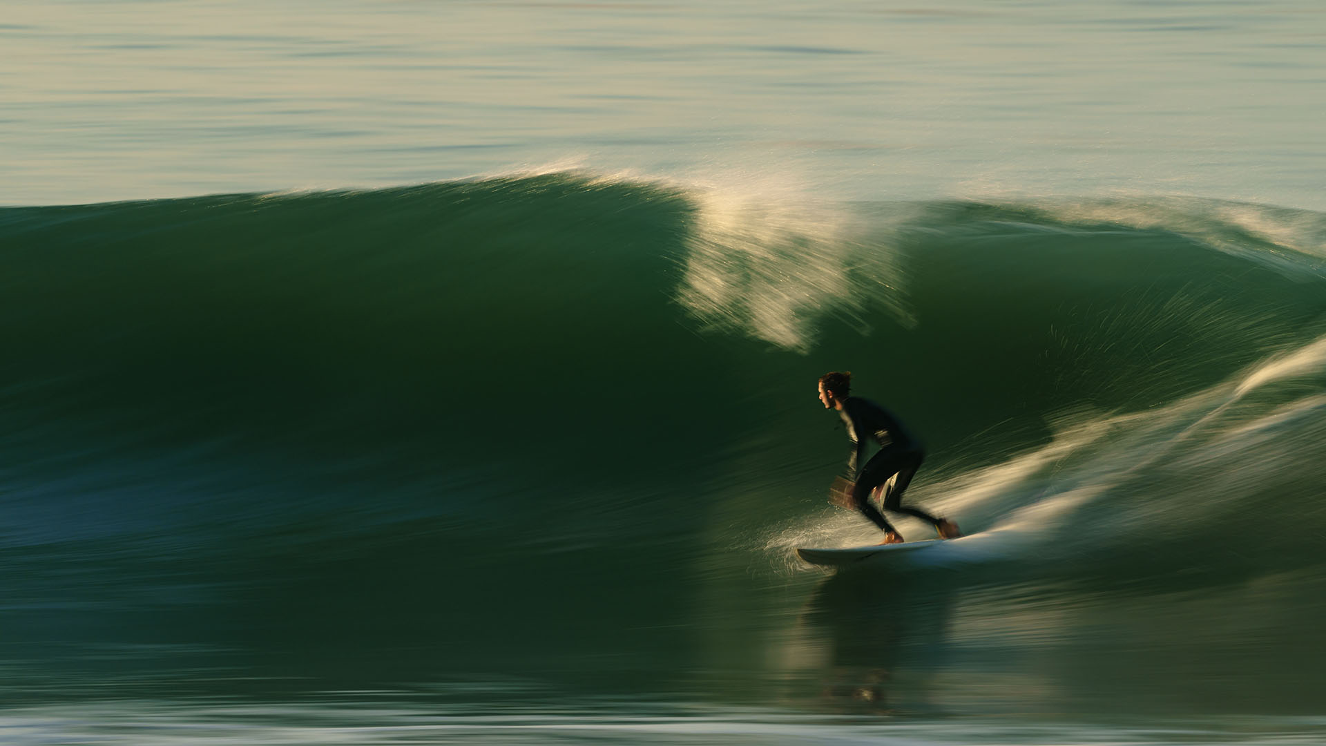 Intermediate surfer riding a point break in Taghazout, Morocco
